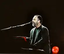 A photo of Billy Joel playing the piano