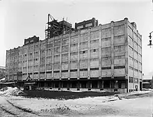 The Buffalo, Rochester and Pittsburgh Railway passenger station was south of the railroad tracks. The freight station, shown here in 1914 during construction, was built between the north side of the tracks and the Erie Canal at 25 Oak Street, opposite the passenger station.