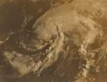 Black and white satellite image of a weakening tropical storm. The white represents clouds and the lines are country and state borders while the black represents land and water. The Gulf of Mexico is at the bottom of the image, with the spiraling hurricane situated over Louisiana. Most of the southern and central United States can be seen in the image.