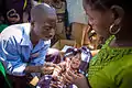 A Yao woman brings her child to a well baby check where it receives an injection in a rural village in northern Mozambique