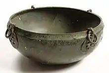 A bowl seen from the side and slightly above, with two hook escutcheons visible on the outside of the rim