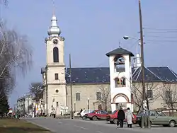 Street in Bajmok, the Catholic Church (right), and bell-tower of the Orthodox church (left)