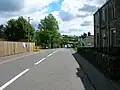 Barrmill's mainstreet with the railway bridge, looking towards Greenhills