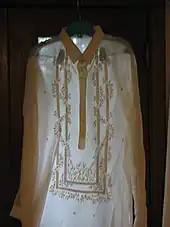 A barong tagalog placed against the light, showing the translucency of the fabric