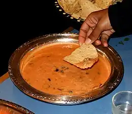 A bean dip served with tortilla chips