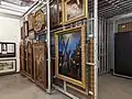 In museums, paintings, framed and unframed, are normally hung on sliding or fixed racking.