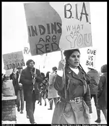 A group of NIYC demonstrators holding signs in front of the BIA office.