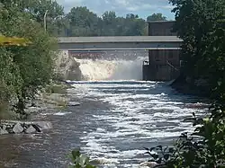 A flowing river with a small waterfall at the end