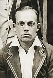 A head shot of a man in a blazer.