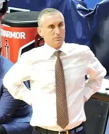 Hurley standing at the sidelines of a basketball game