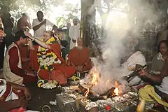 Satguru Bodhinatha Veylanswami gives samaya diksha, initiation into the sacred Aum Namah Shivaya mantra, to a devotee at Tirunnavamalai in 2008.