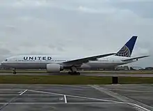 Aircraft landing approach. Side view of a twin-engine jet in flight with flaps and landing gear extended.