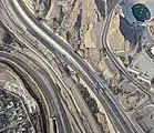 This aerial view of the Mexico–US border near the Sun Bowl stadium in El Paso, Texas, shows the state of construction of the Border West Expressway crossing above the railroad tracks (center), in December 2017.  The neighborhood at the lower left is in Ciudad Juárez, Chihuahua, Mexico.