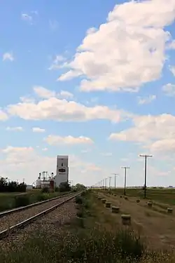 Looking down railway tracks towards the grain elevator in Bracken.