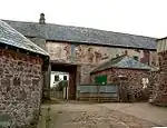 Old stone building with archway.