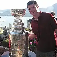 Burke standing next to the Stanley Cup.