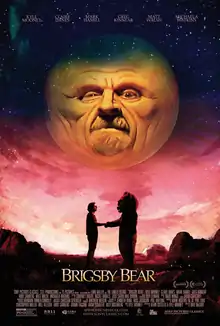 A man and a person in a bear costume shake hands below a large planetoid with a face.