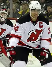 A defenseman in front of a goaltender during a game of hockey