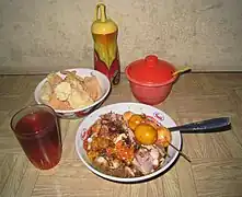 Bubur ayam with premature chicken egg satay, sold in a warung in Jakarta.