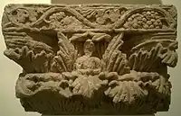 The Buddha, within the foliage of a Corinthian capital.