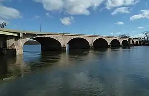 A large masonry bridge, seen from river level