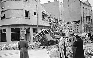 a damaged building and damaged tram