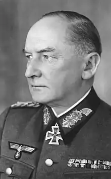 A man wearing a military uniform and neck order in the shape of a cross.