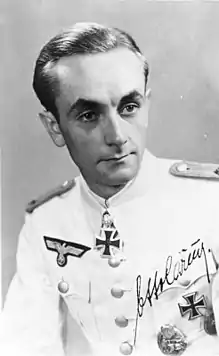 A man wearing a military uniform with an Iron Cross displayed at the front of his uniform collar.