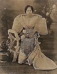 Woman in terno with stiffened "butterfly" sleeves