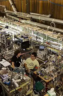 Woman talking to man in laboratory setting.