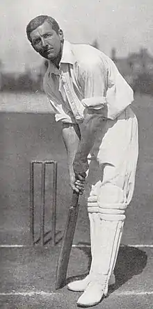 A cricketer in his batting stance.