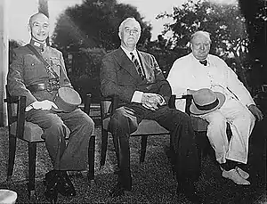 Three men, Chiang Kai-shek, Roosevelt and Churchill, sitting together elbow to elbow