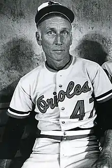 A black-and-white photo of Ripken seated, wearing baseball gear