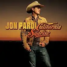 A man wearing a cowboy hat, plaid shirt, denim jeans and jacket with an early sunrise behind him. The artist's name and album title are superimposed in the center, colored dark yellow and orange respectively.