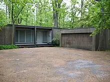 A brown modernist squarish house and garage is pictured