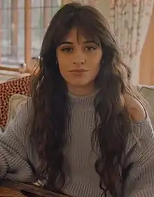 Cabello looking towards a camera