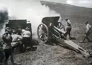 A 10.5 cm Feldhaubitze M.12 with a box trail carriage.  Below the breech is an open space to increase elevation.