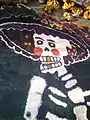 Image done in colored sawdust for Día de Muertos