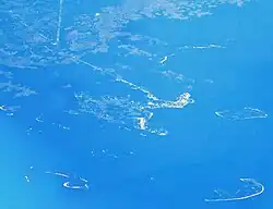 Aerial view of Cedar Key and its outlying islands, illustrating the extremely small size of the city:  The fork at State Road 24 and County Road 347 (the only two access roads) can be seen in the upper left.