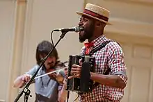 Musician Cedric Watson playing a diatonic button accordion