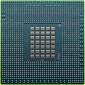 The underside of the 90 nm Cell/B.E. processor showing its 1242 solder balls, each 0.6 mm in diameter, and its array of 35 capacitors