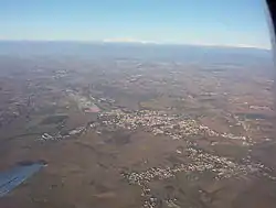 Aerial view of Cervignano and Terzo di Aquileia; the Alps in the background.