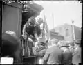 Charles Evans Hughes and his wife shake hands with supporters at Chicago's Union Station