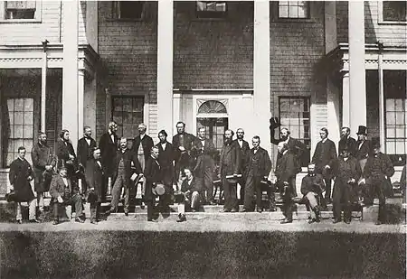 Delegates from the Legislatures of Canada, gathering  on the steps of Prince Edward Island's Government House for the Charlottetown Conference – Photo by George P. Roberts on September 11, 1864.