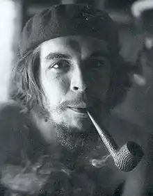 Che Guevara wearing a beret and smoking a pipe