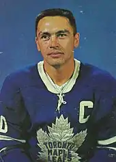 Armstrong poses for a studio shot in his Maple Leafs uniform. His sweater features a "C" patch denoting he was captain of his team.