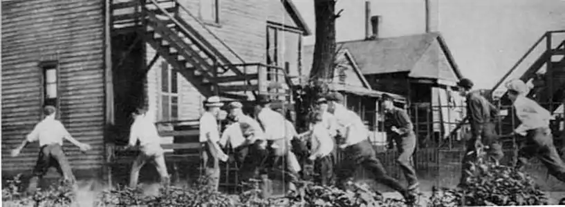 A white gang looking for African Americans during the Chicago Race Riot of 1919. This and a subsequent  picture at The Crisis Magazine 1919 Vol 18 No. 6 is part of a series of the Chicago race riots of 1919.The first pictures of the white gang chasing a victim are at and