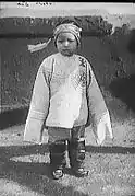 Chinese American child in embroidered jacket, 1900.