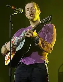 Martin playing the guitar on Coldplay's Viva la Vida Tour in 2008, the same year of the song's release.