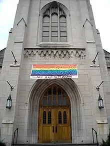  Pride flag banner hung over the entrance to the Church of the Pilgrims in Washington, D.C. with the words "ALL ARE WELCOME" printed underneath